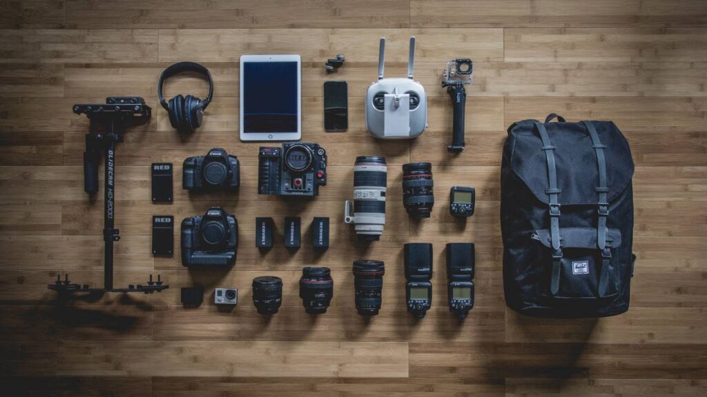 Photo equipment and a backpack laid out on the floor